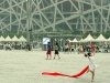 A girl showing off here gymnastic skills outside the Bird's Nest Olympic Stadium